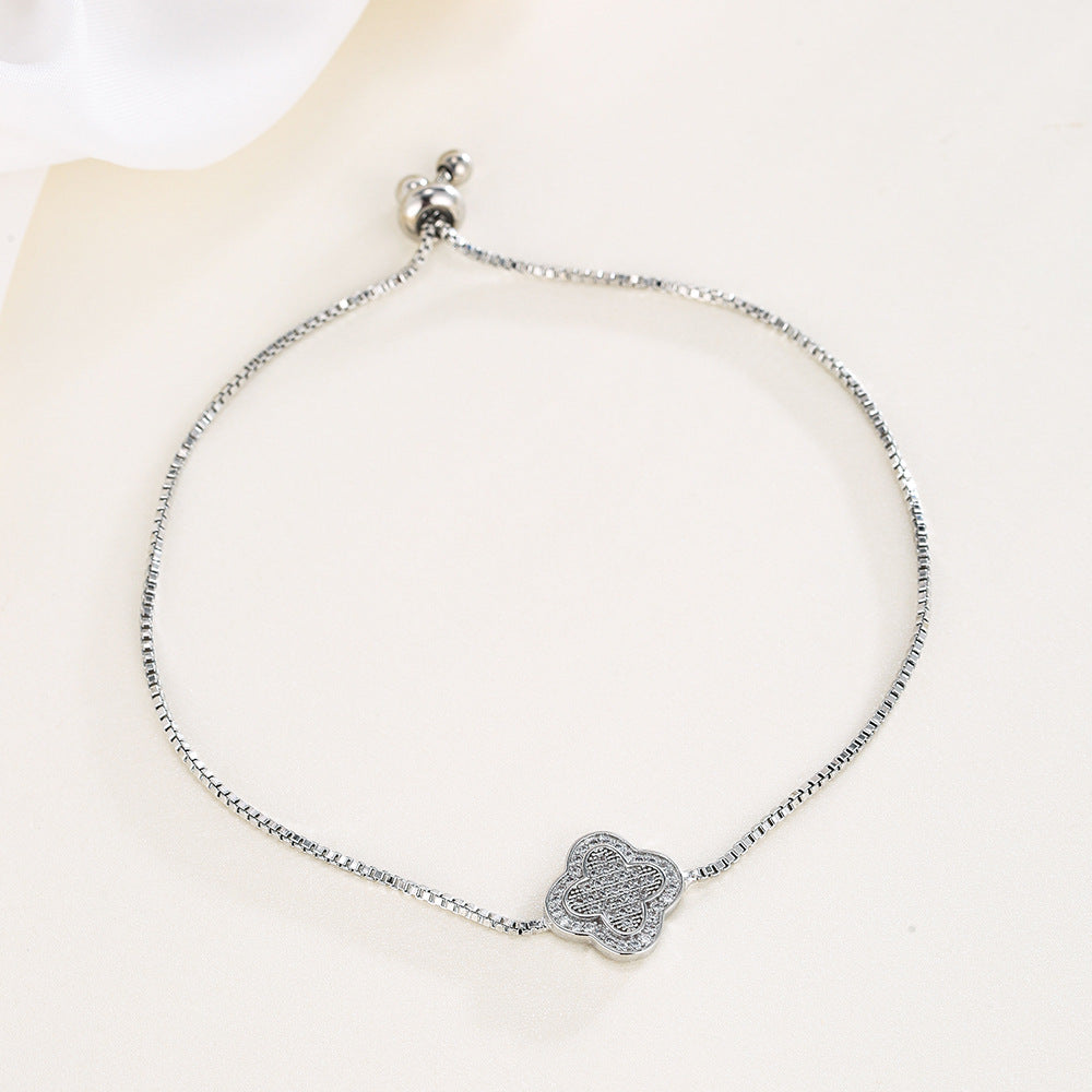 Silver bracelet with a decorative clasp on a white background