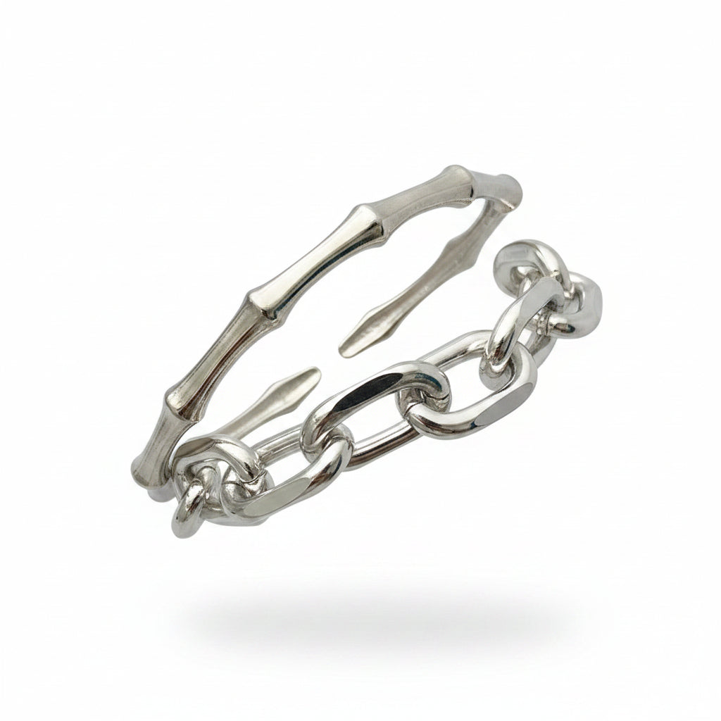 Silver chain bracelet on a wrist with a plain background