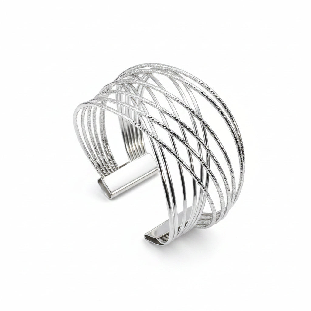 Silver cuff bracelet on a beige fabric background
