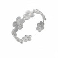Silver floral bracelet with measurements and product details on a white background