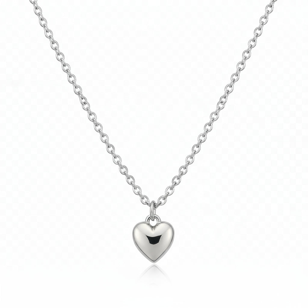 Silver heart-shaped pendant necklace on a beige background
