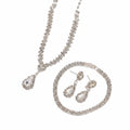 Silver jewelry set with necklace and earrings on a beige background