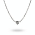 Silver necklace with a round pendant on a person wearing a white garment.