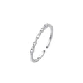 Silver open ring with small diamonds on a white background