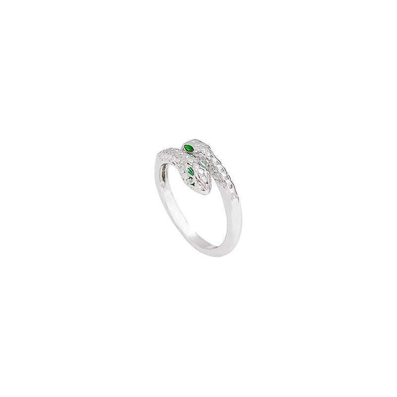 Silver ring with a green gemstone on a white background