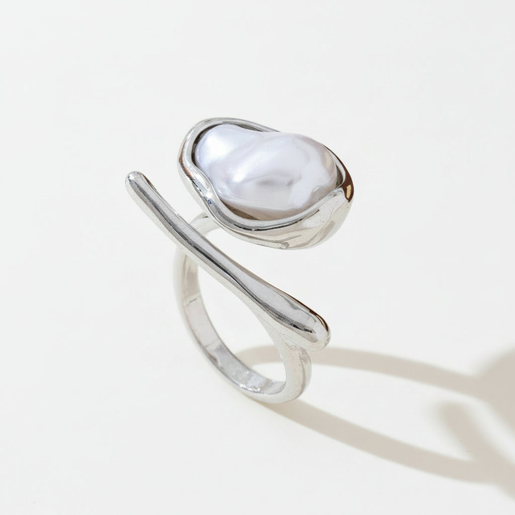 Silver ring with a large pearl on a light surface