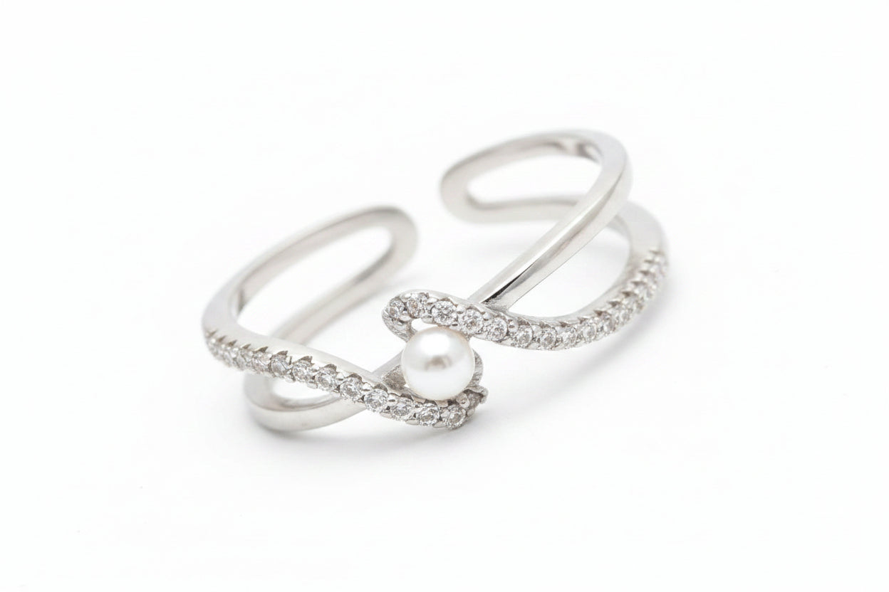 Silver ring with a pearl on a soft surface