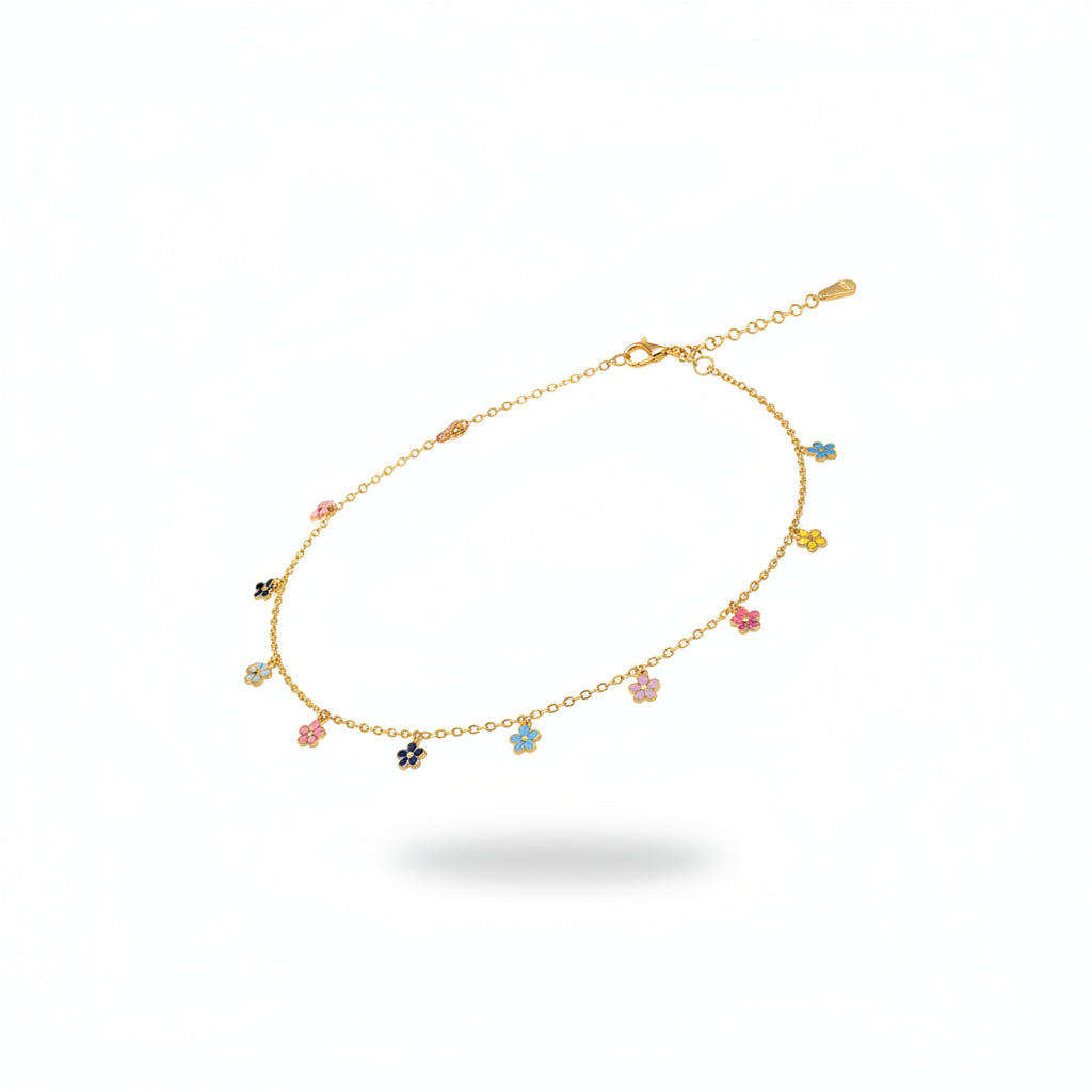 Silver sandal worn on a foot with a anklet featuring colorful beads on a wooden floor.