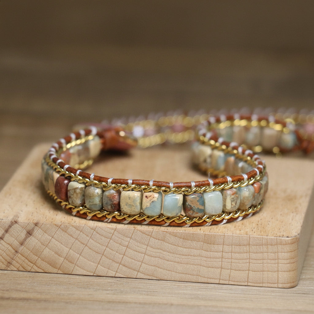 Stack of beaded bracelets on a wooden surface with a blurred background