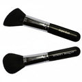 Two makeup brushes with black bristles and silver handles on a white background, labeled 'Angled Blush' and 'Mommy Makeup'.