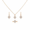 Woman wearing a diamond necklace, ring, and earrings on a neutral background
