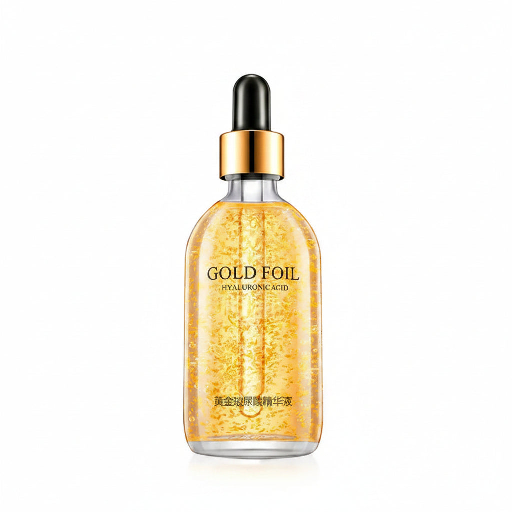 Gold foil serum bottle with dropper and packaging on a white background